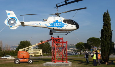Transporté par camion, l'hélicoptère aux couleurs de Marseille-Provence 2013, prêté par Eurocopter, a été tracté par une grue, puis posé sur son socle hier après-midi sur le rond-point à l'entrée de l'aéroport - Photo Brian Orsini