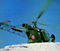 Alouette 2 F-MJAZ Gendarmerie pilotée par André VIOT se pose au sommet du Dôme des Écrins, le 23 août 1961 (Mission : pique-nique aux Écrins) ; le lieutenant Pierre Rossignol est à croupetons devant la machine - Photo DR collection Jean-Marie Potelle