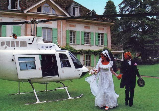 Agusta Bell 206 F-GDRD HELI ALPES stationné sur la DZ de la Villa des Roses à Talloires (74) photo prise lors d'un mariage (après 1984 et avant le 12 janvier1989) - Porte coulissante latérale visible - Photo DR carte postale publicitaire HELI ALPES